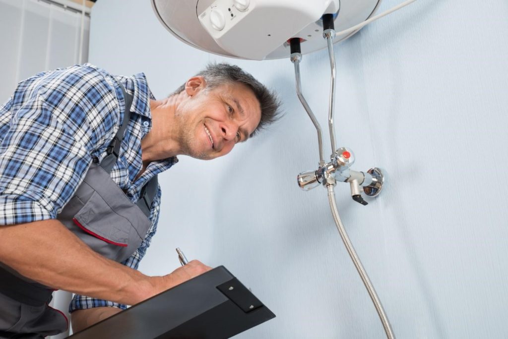 plumber assessing sink water lines