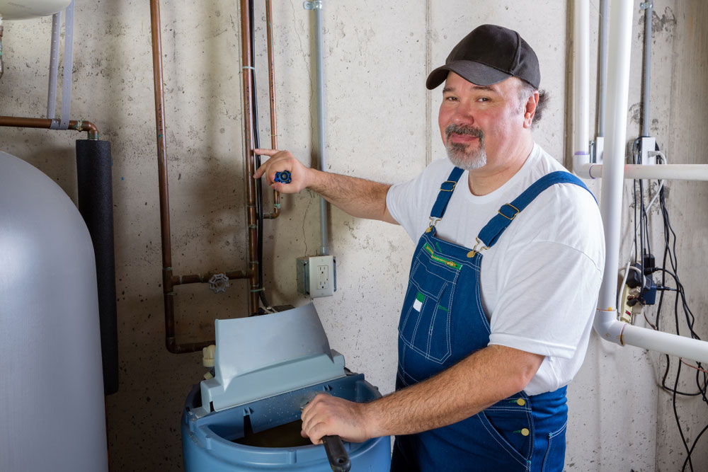 plumber installing water softener system